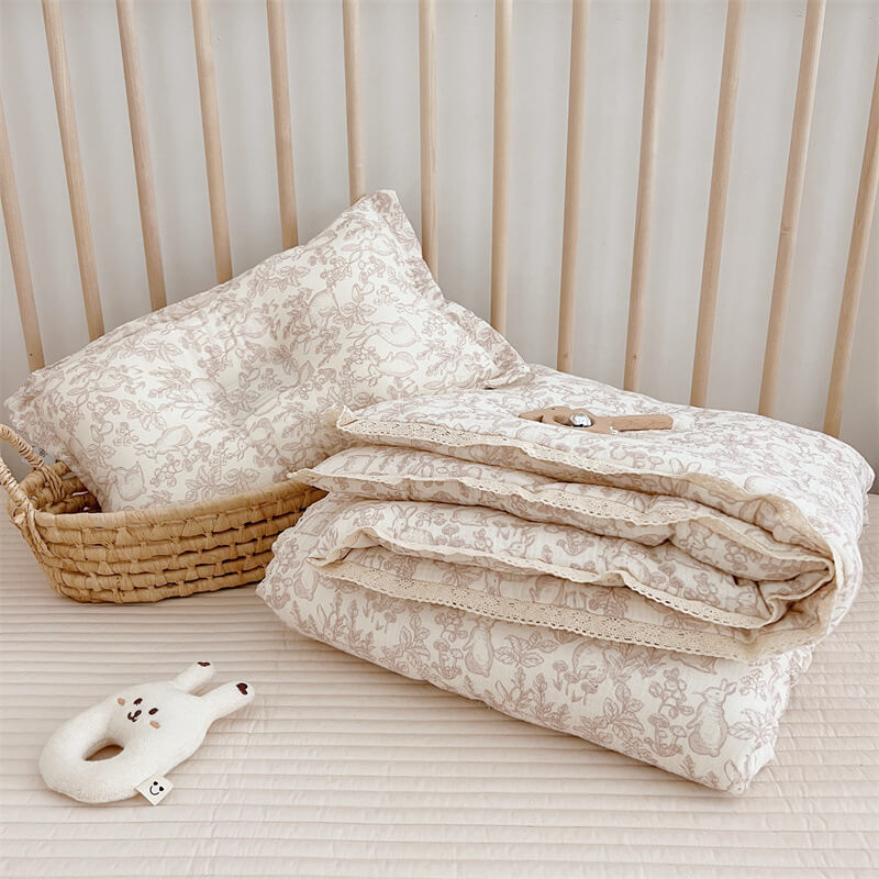 Woodland baby comforter with lace trim and forest animal print