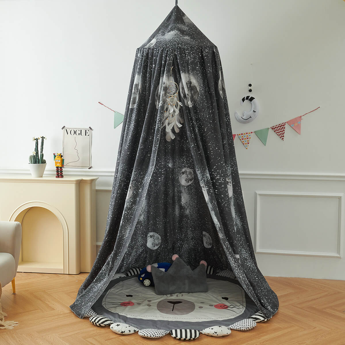 Black Galaxy Kids Bed Canopy set up as a play tent on the floor, with a lion mat and a gray crown pillow for a cozy nook