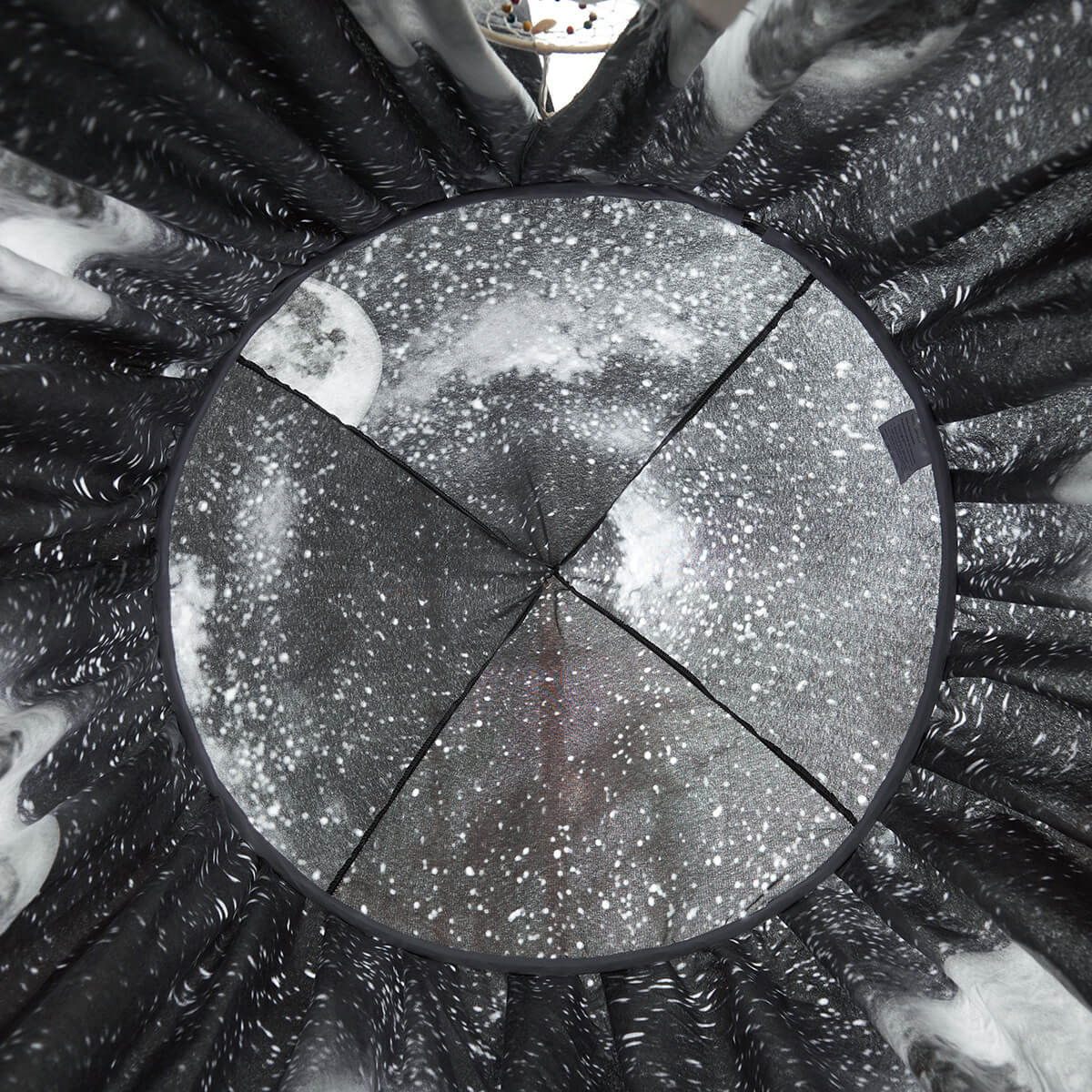 Top-down view of the Black Galaxy Kids Bed Canopy, showing the circular ceiling design with moon and stars