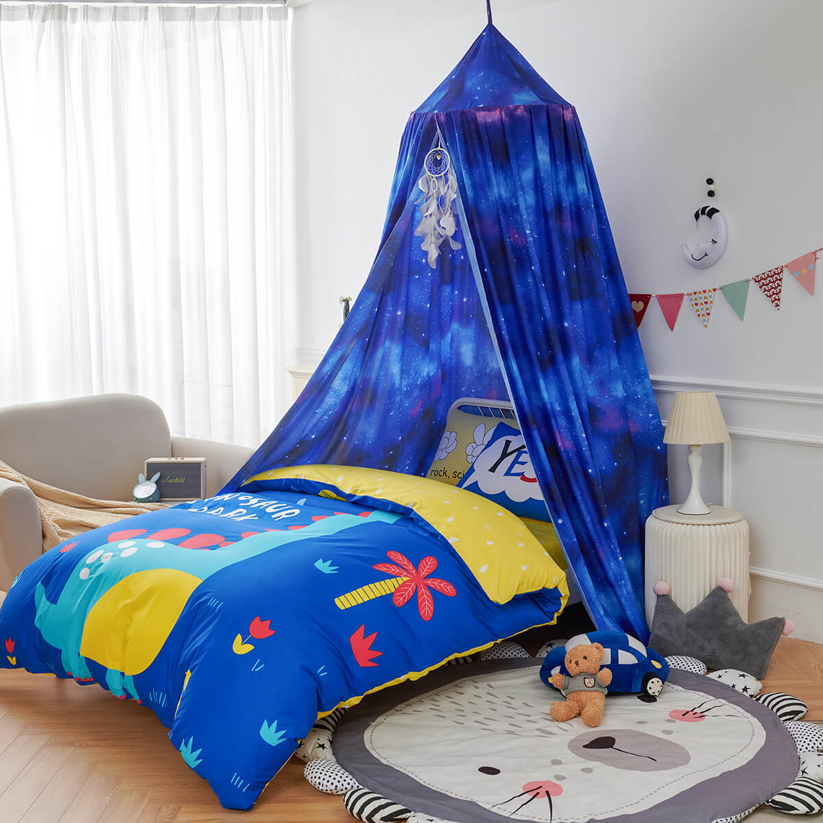 Blue Starry Sky Kids Bed Canopy over a bed with a colorful dinosaur duvet cover and a lion-shaped mat.