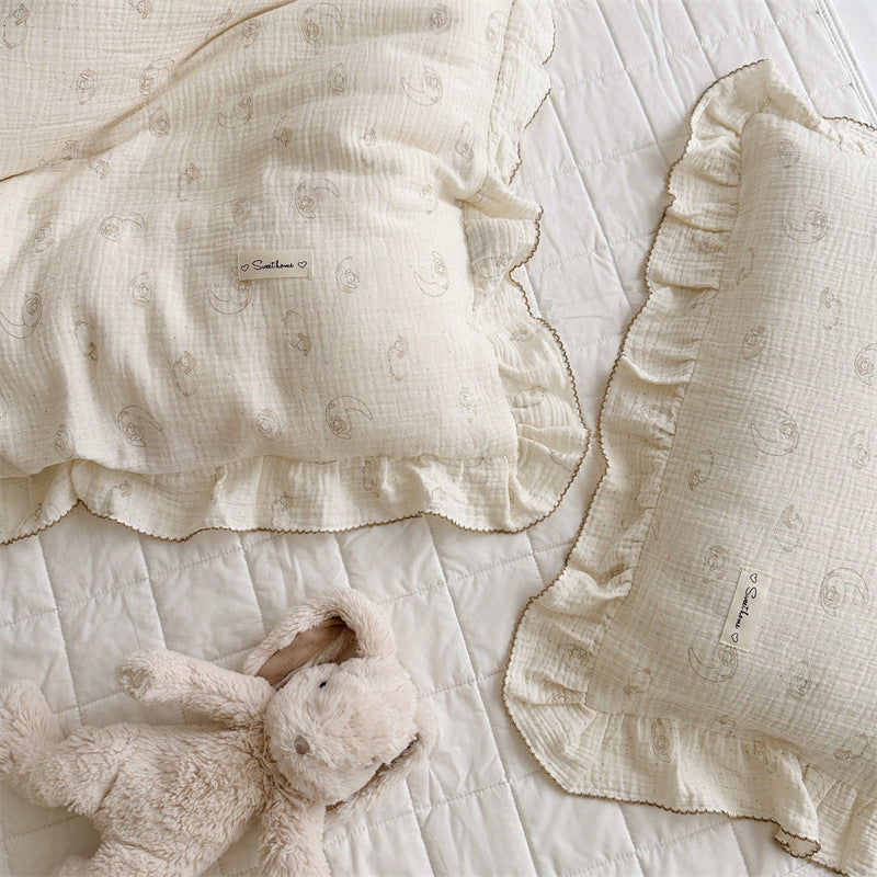 Lamb print ruffle duvet cover set with neutral trim and gentle animal sketches, paired with bunny toy