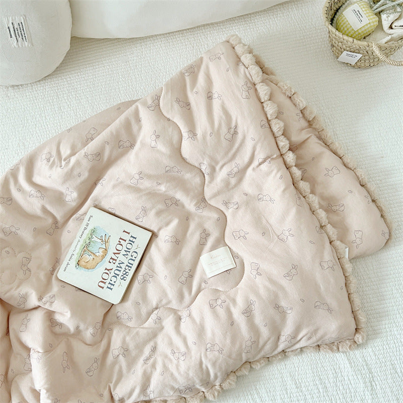 Khaki kids cotton comforter with subtle bunny pattern on a white surface