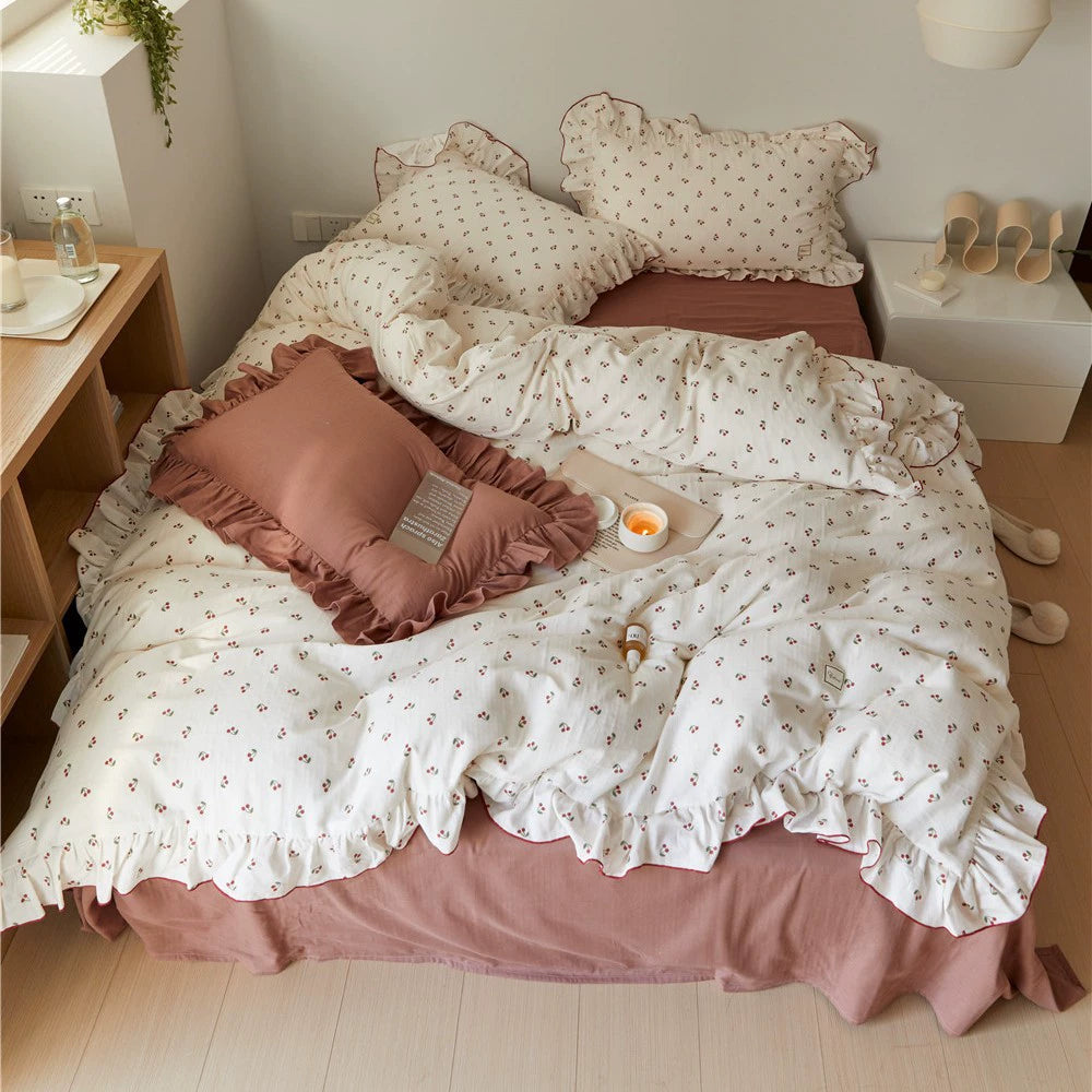 A neatly folded soft cotton muslin bedding set with a cherry print, showcasing its reversible pattern and textured fabric.