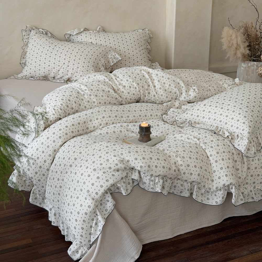 A cozy bedroom scene with the muslin bedding set on a bed, highlighting its crinkled texture and beautiful ruffles.