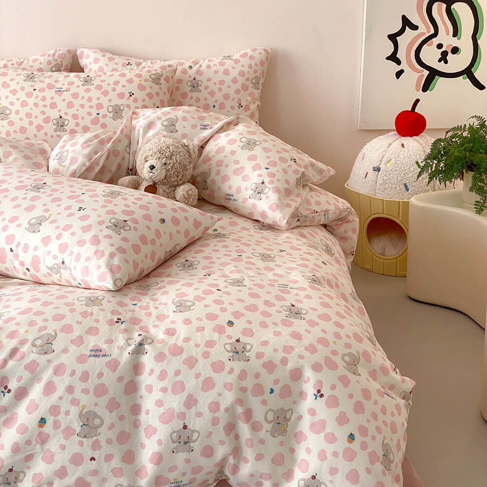 Pastel pink elephant kids bedding set with plush bear decor, cream base, pink spots, and matching pillowcases