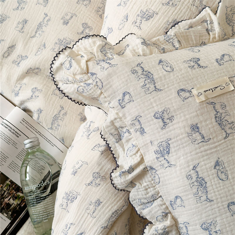 A detailed shot of the queen-size duvet cover set, highlighting the blue cat print on the cotton gauze fabric and the ruffled pillowcase
