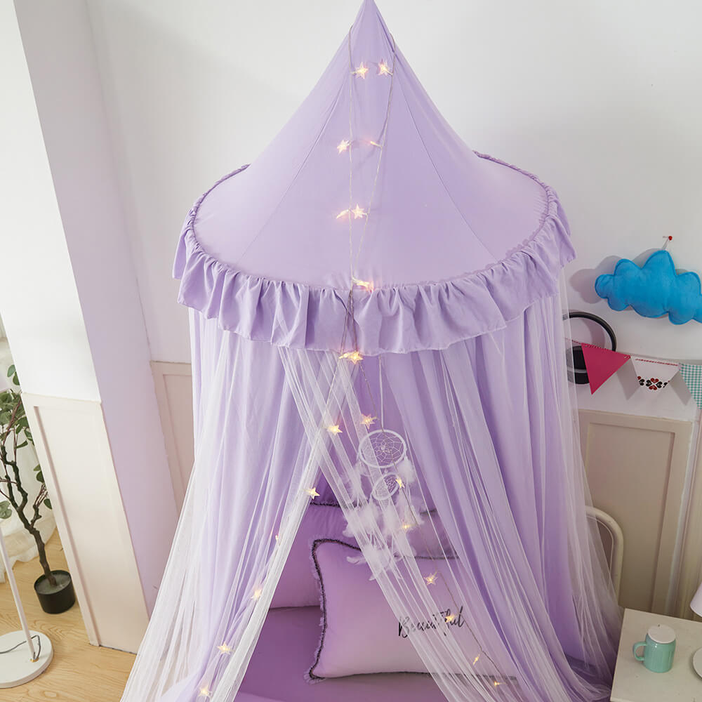 Close-up of a purple double-layer kids bed canopy, showing the ruffled top and sheer mesh with star lights for a whimsical decor.