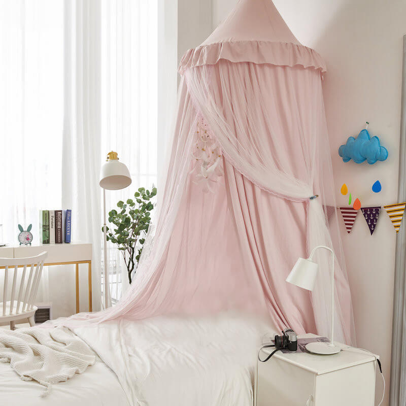 palepink double-layer kids bed canopy with sheer mesh and a ruffled top, creating a princess-style nursery room decor.