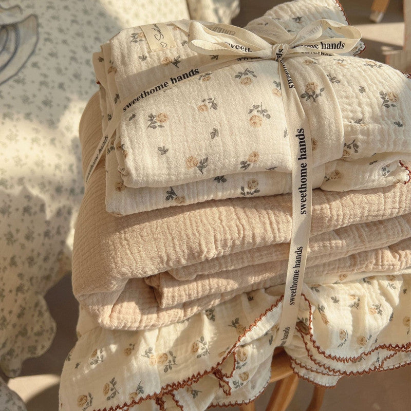 Folded rose floral muslin bedding set tied with ribbon