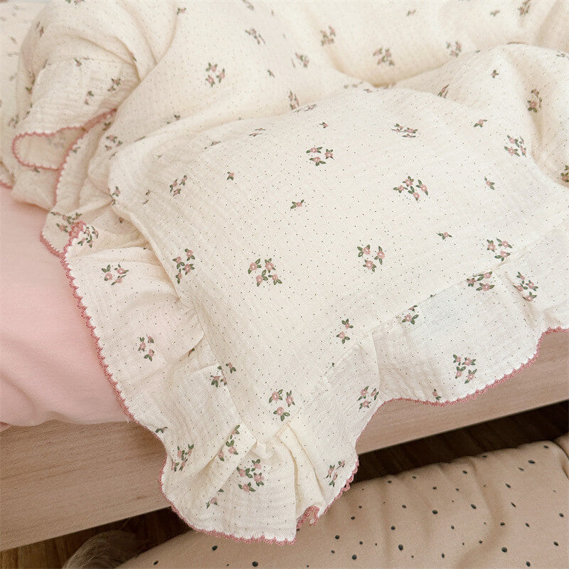 Close-up of duvet cover with small primrose floral print and pink ruffle edge