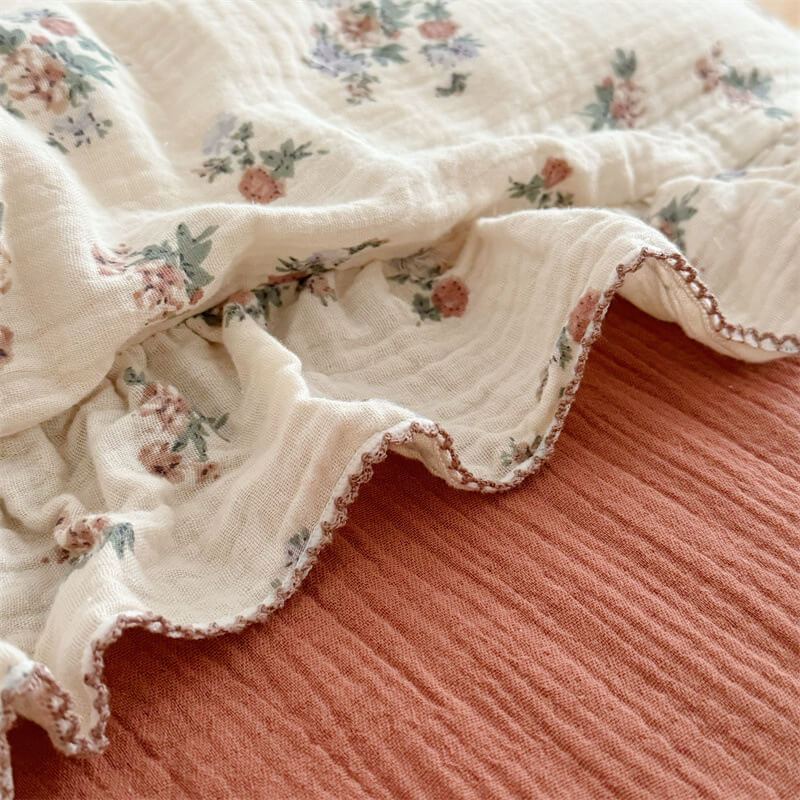 Close-up of ruffled cotton gauze edge with floral bouquet print