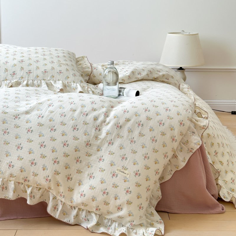 Azalea floral ruffle bedding set styled with pillow shams, duvet cover, and solid pink crinkled cotton flat sheet
