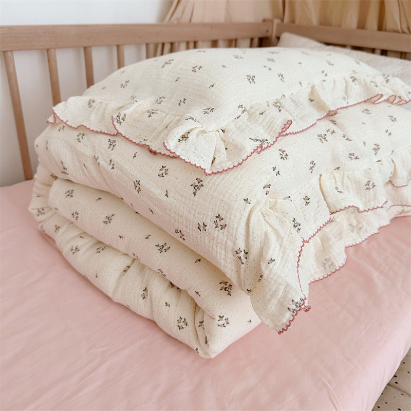 cotton muslin Primrose Floral Ruffle Duvet Cover Set on a crib