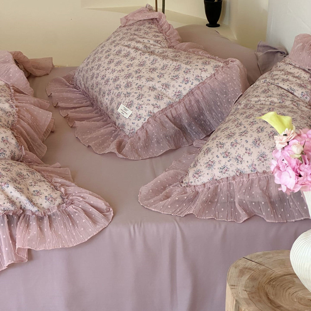 Arrangement of three Lavender Floral Pillow Shams, clearly displaying the mauve and white polka-dot chiffon ruffled trim and the light floral pattern on the mauve bed sheet.
