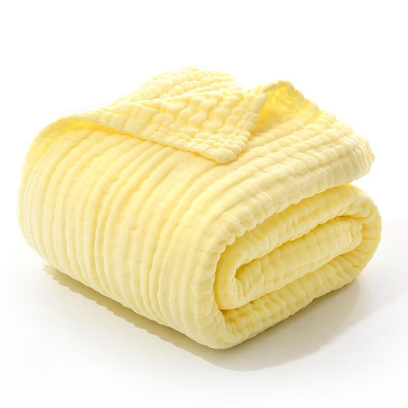 Folded 6-layer cotton muslin swaddling blanket in a solid pale yellow color.