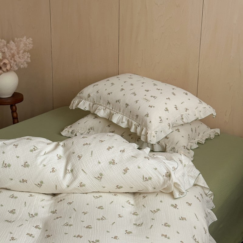 cotton muslin Bunny print duvet cover with ruffled trim styled on bed