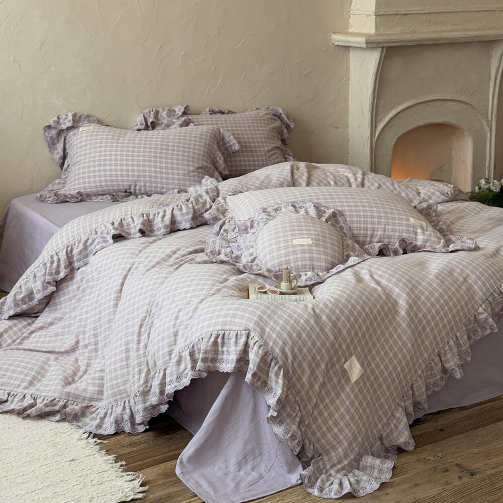 Lavender plaid ruffle bedding set displayed on bed