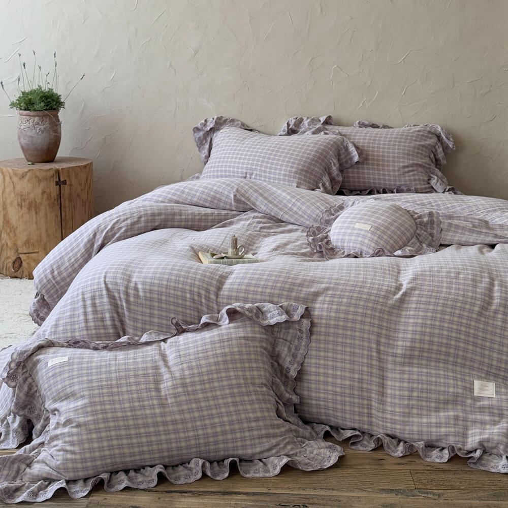 Close-up of ruffled lavender plaid pillowcase and comforter