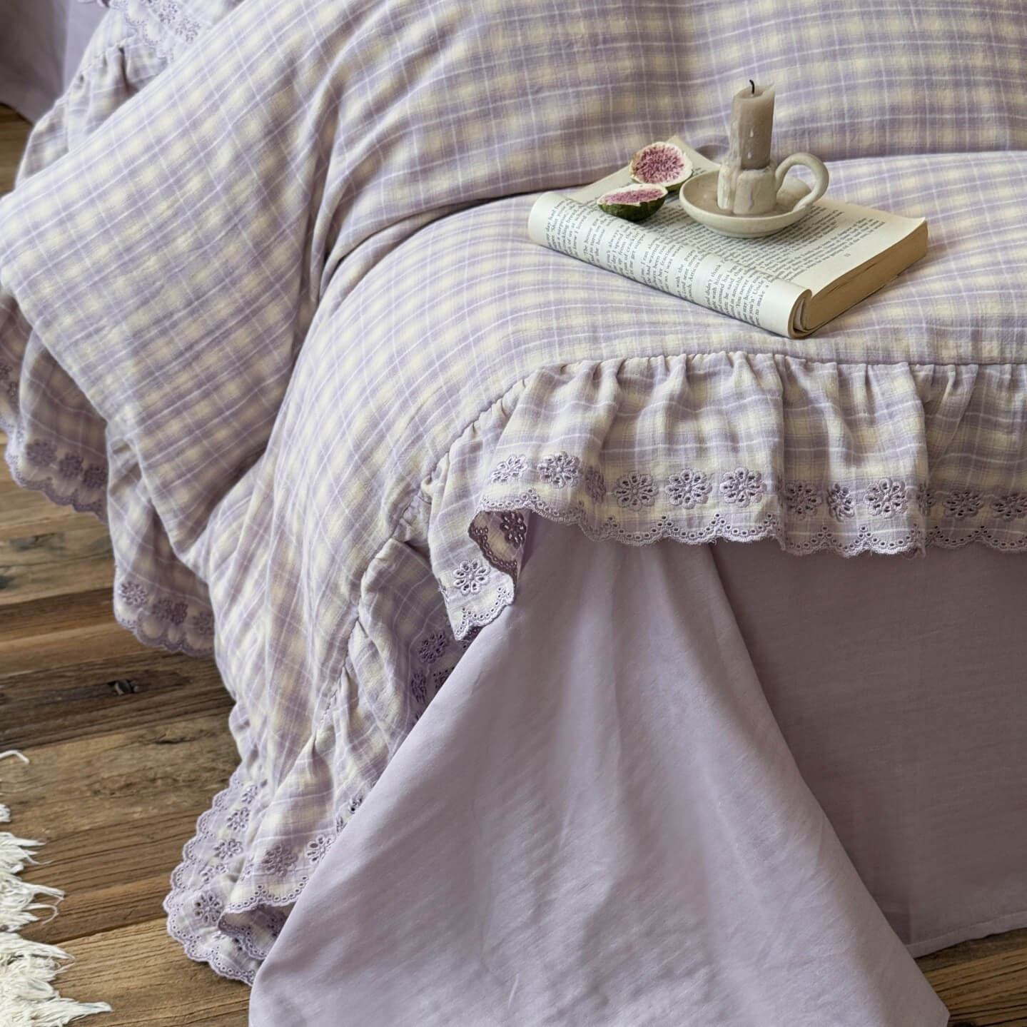 Detailed view of lace-trimmed ruffle edge on plaid cotton muslin bedding