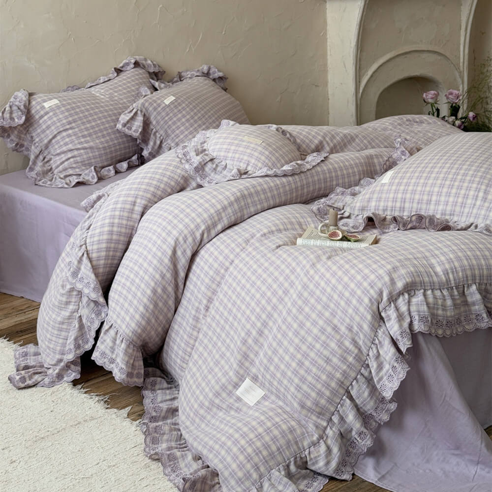 Cozy lavender plaid bedding set styled in a rustic bedroom