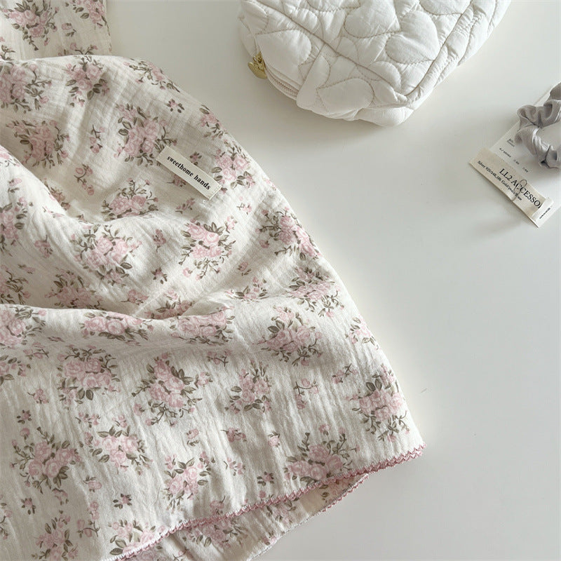 Close-up of rosebud pink floral muslin baby blanket