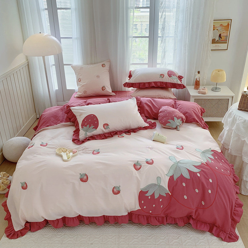 Bedding set with strawberry design in a bedroom