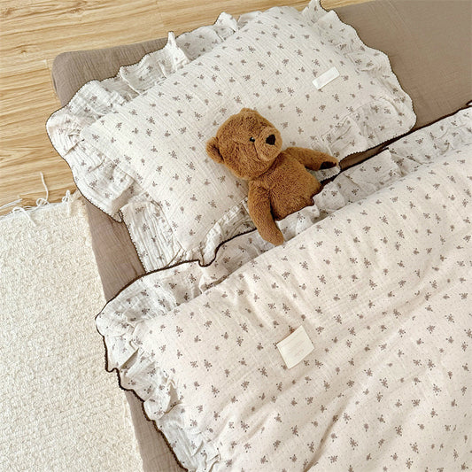 Kids bed styled with taupe floral ruffled cotton gauze duvet cover set and matching pillow, soft neutral tones