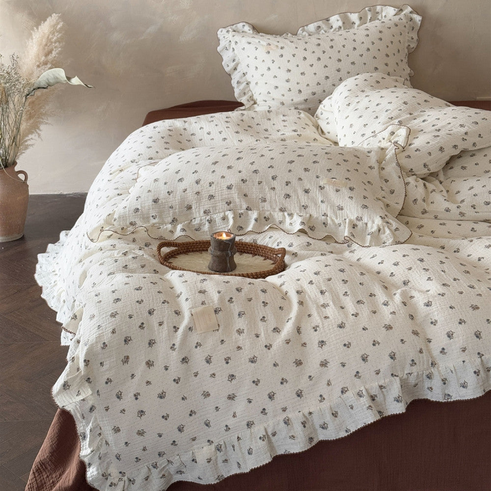Front view of ruffled cotton duvet cover and matching floral pillow