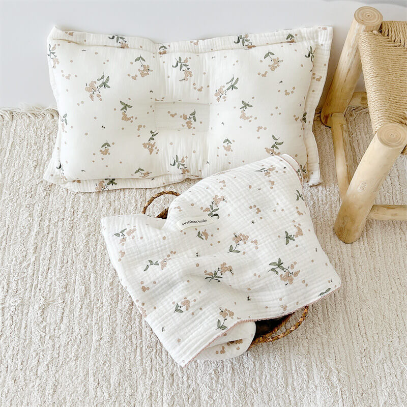 A matching laurel floral muslin baby blanket and pillow set.
