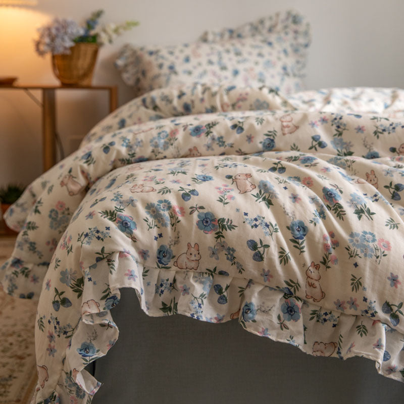 A close-up of the blue and pink floral bunny bedding set, showcasing the colorful flowers and rabbits printed on the cotton gauze.