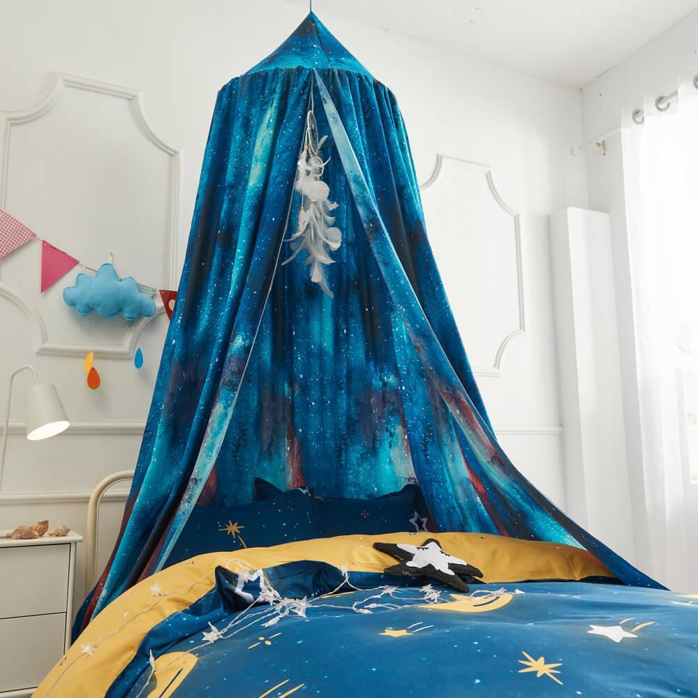 Space-themed kids' bed canopy with blue universe print and yellow star duvet.