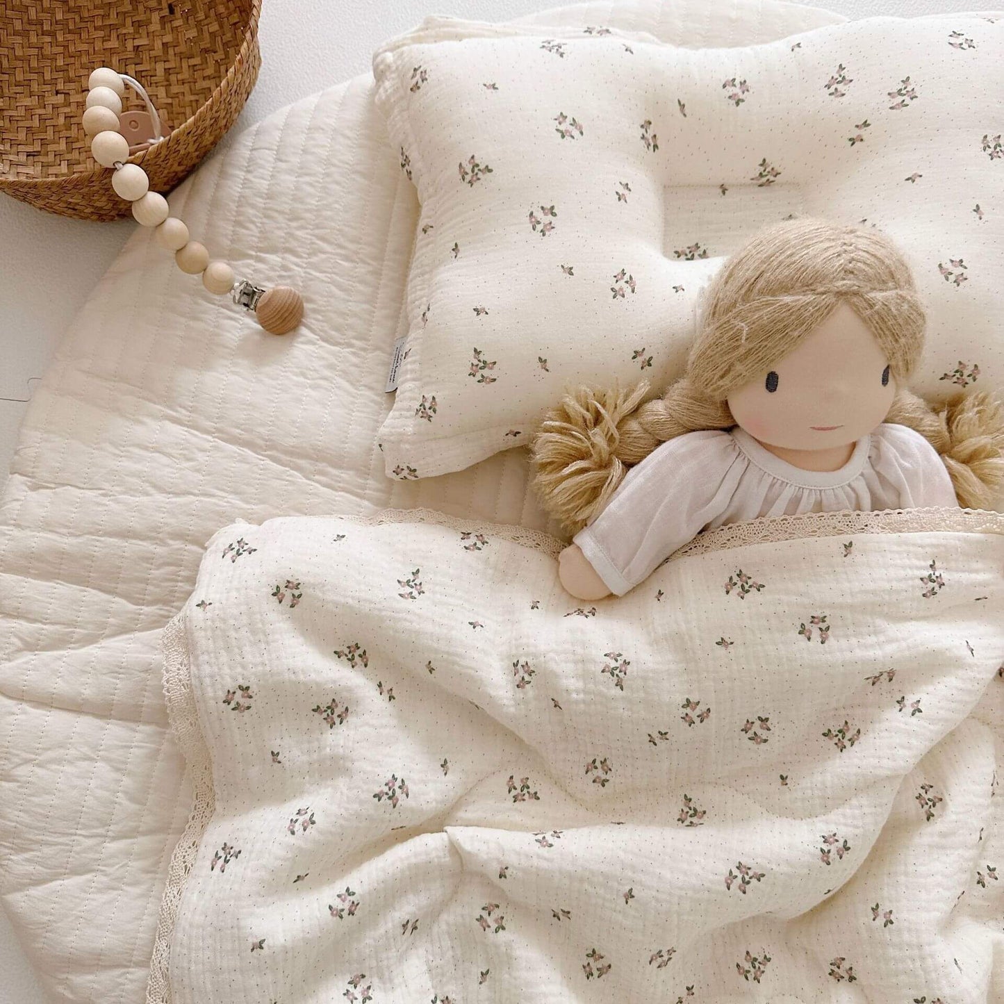 baby quilt and pillow set displayed in the crib