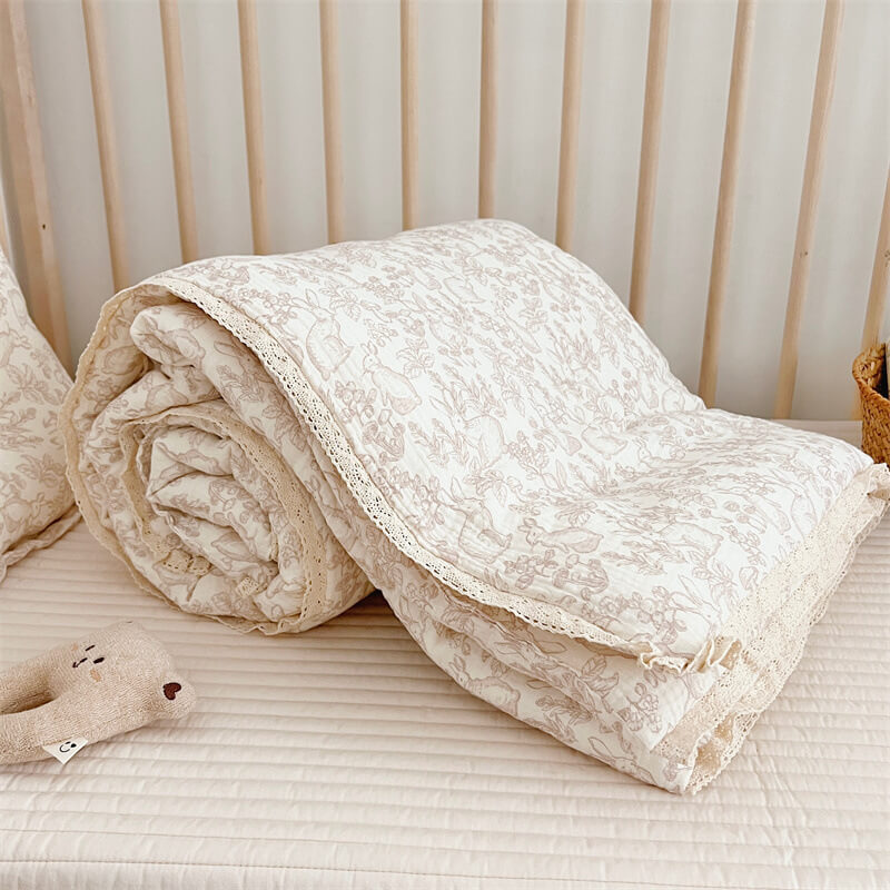 Forest animal baby bedding styled in toddler bed