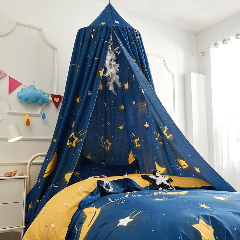 Nursery room decorated with a dark blue star-patterned bed canopy and matching duvet cover.