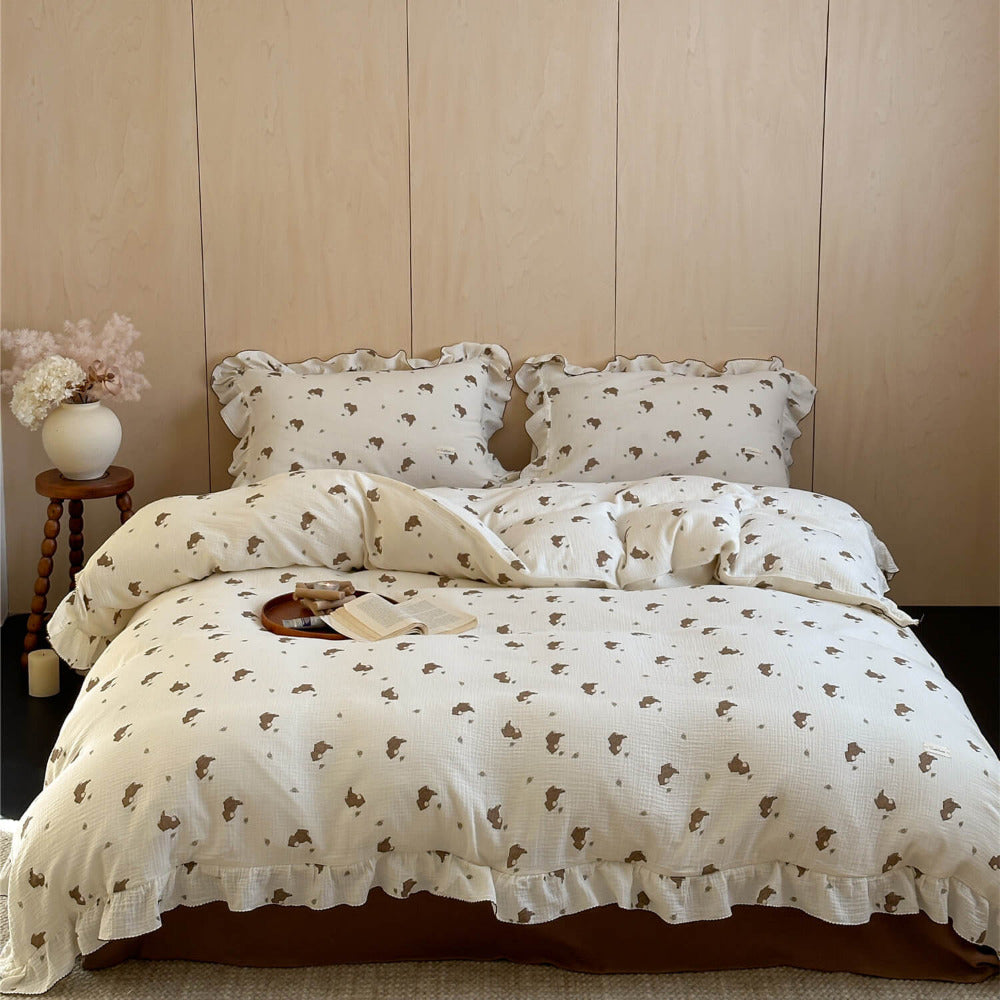 Full view of ruffled bear print duvet cover and pillowcase(s) on brown sheet