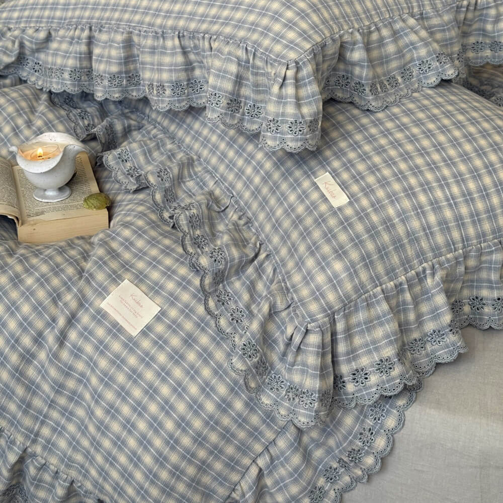 Layered view of dusty blue plaid bedding set with matching pillowcases