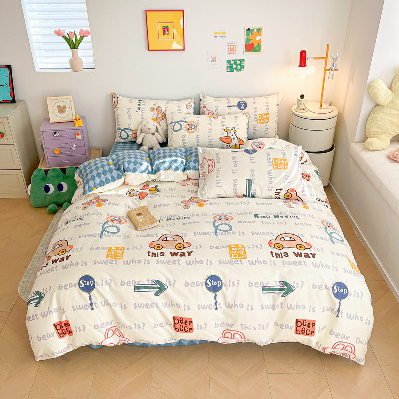 A boy's bedroom with a twin-size bed featuring a cotton cartoon car bedding set. The bedding has a playful pattern of cars, road signs, and text, styled with decorative pillows
