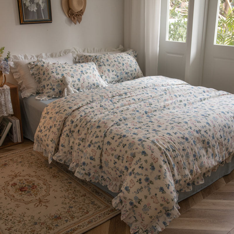 A full-view image of the blue floral bunny bedding set in a bedroom, highlighting the cheerful and playful design.