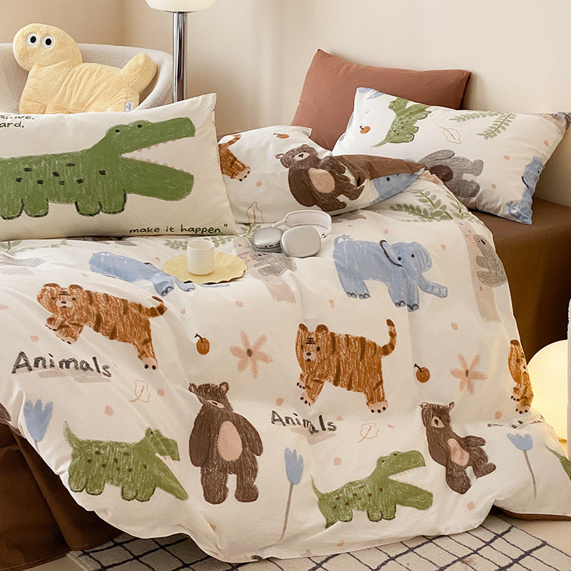 A close-up on the white animal print duvet cover showing cartoon illustrations of a brown bear, a blue elephant, and a green alligator.
