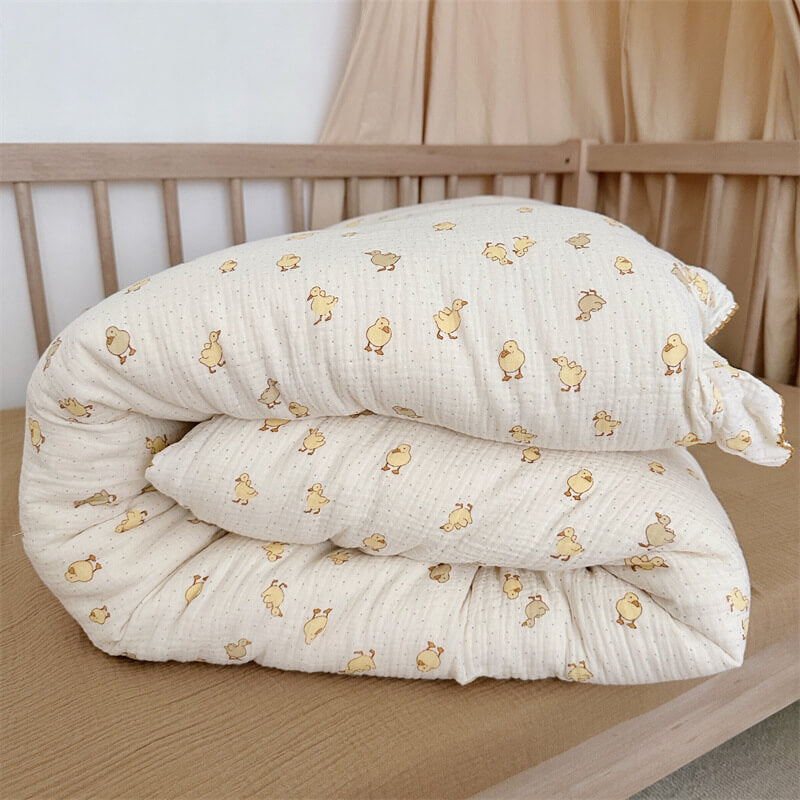 Folded duckling print comforter showing breathable muslin fabric