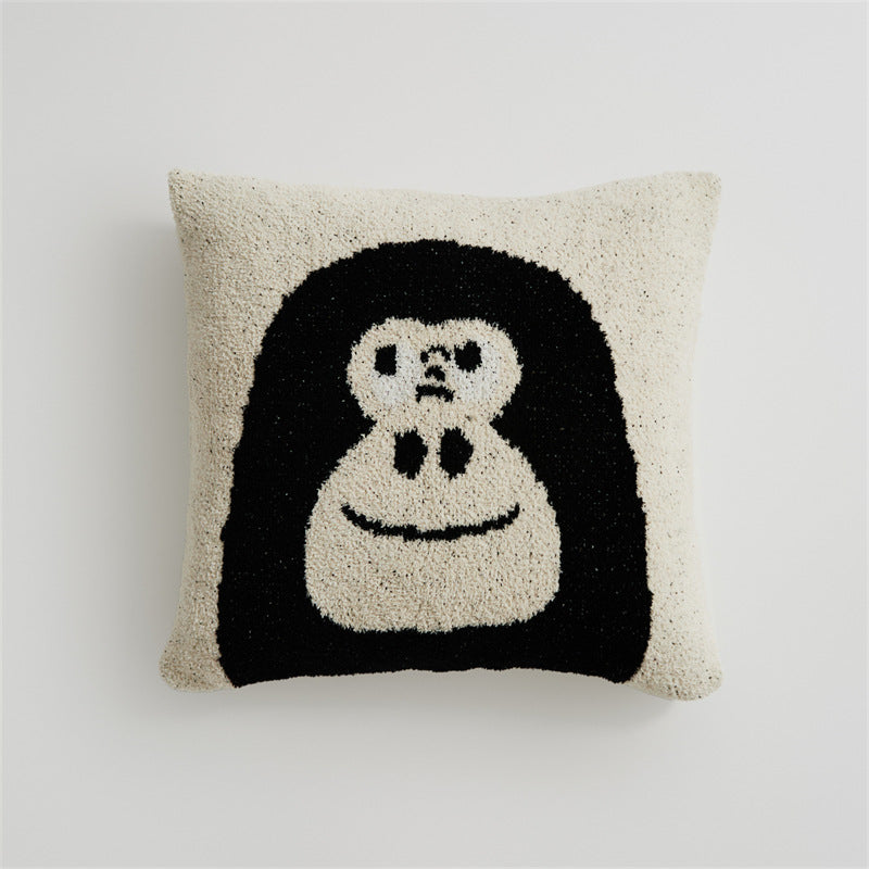 A close-up of a black and white chimpanzee "Face" design pillowcase on a white background, showcasing the embroidered details.