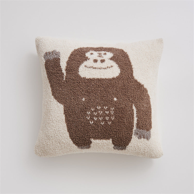 A close-up of a brown and beige chimpanzee "Hello" design pillowcase on a white background, highlighting the plush texture.