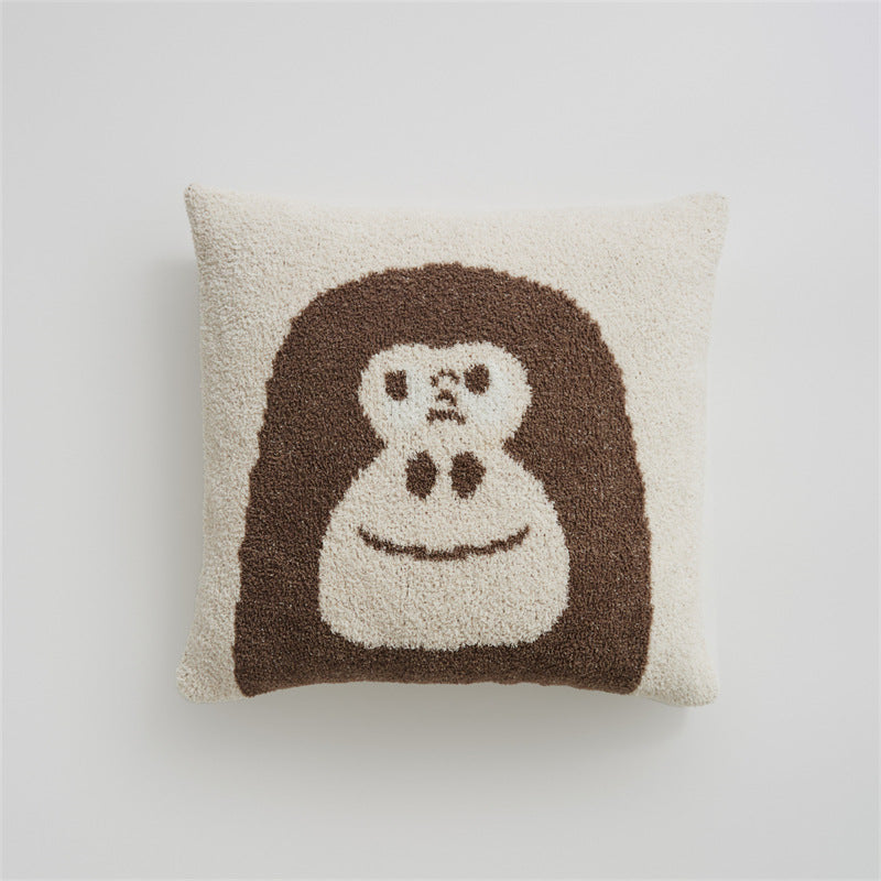 A close-up of a brown and beige chimpanzee "Face" design pillowcase on a white background, highlighting the soft texture.