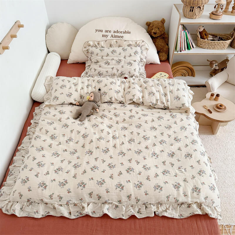 Cotton gauze bedding with muted red and lavender flowers, ruffle trim
