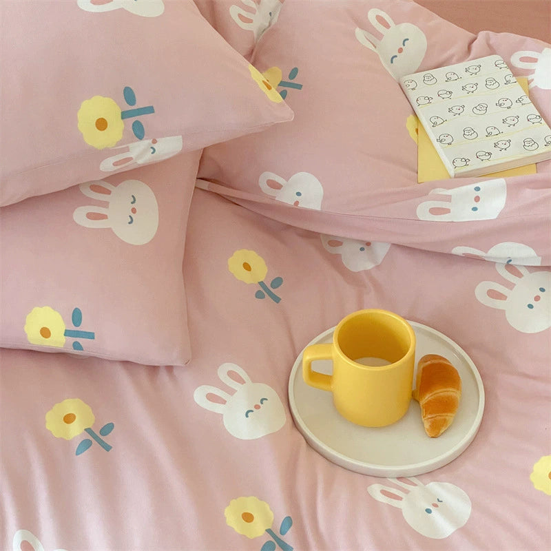 Close-up of bunny and flower print on pink cotton jersey bedding