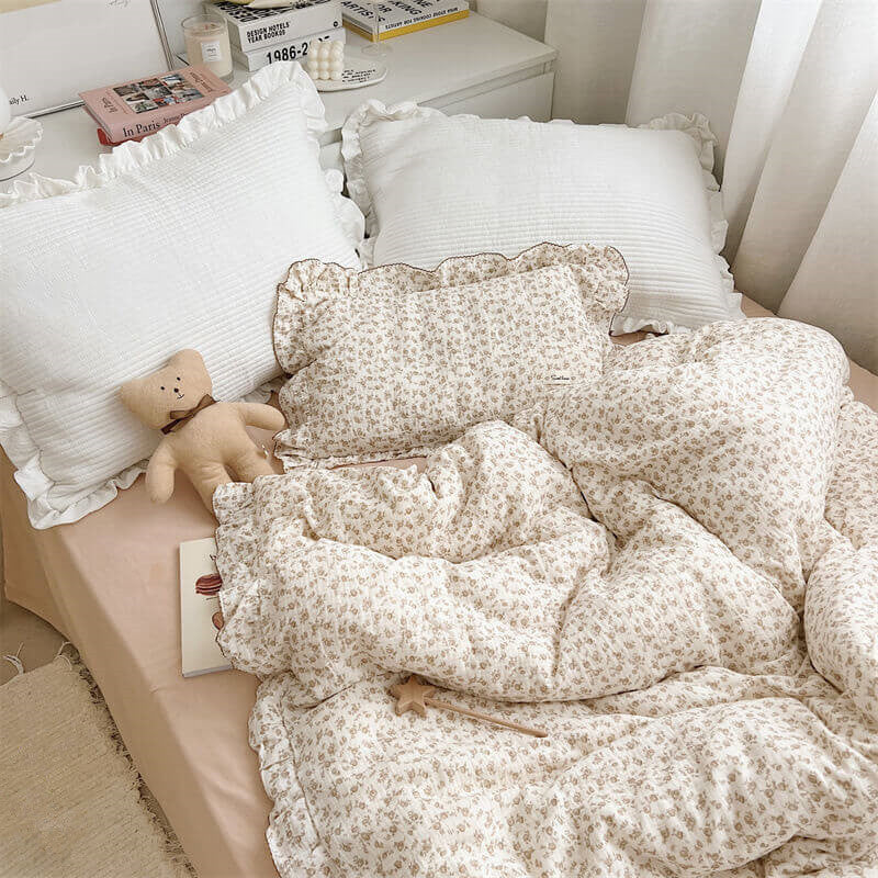 Vintage ruffle duvet cover set with camellia floral muslin fabric, styled on a bed with matching pillowcase.
