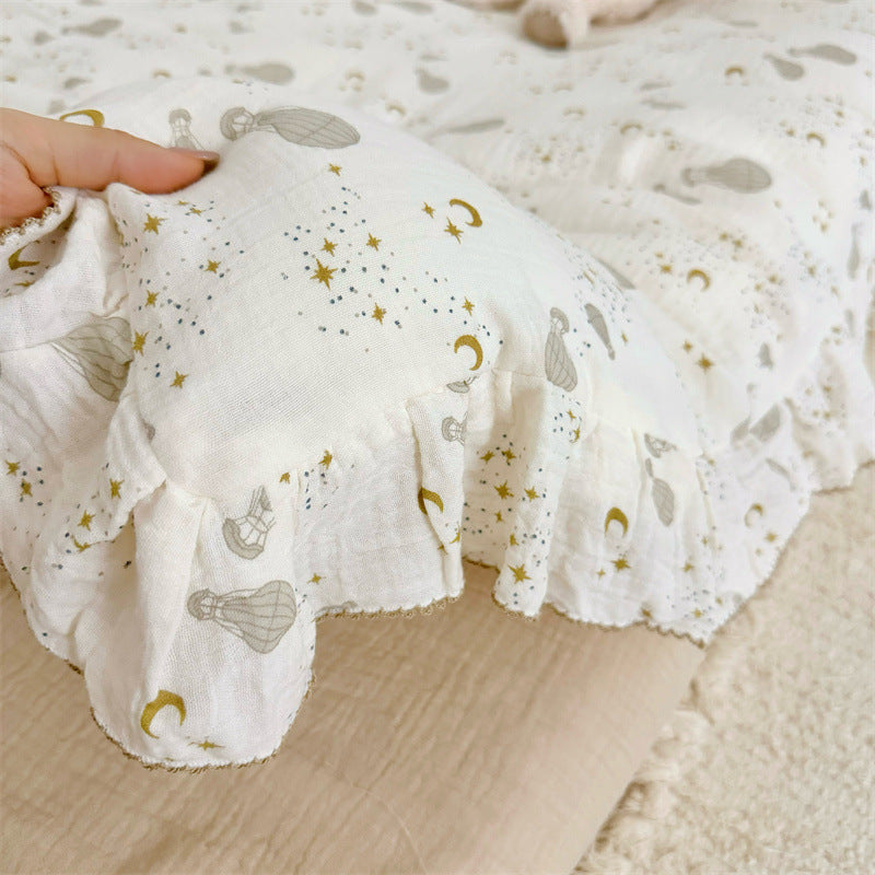Detail of cotton gauze ruffled duvet cover with hot air balloon and stars print