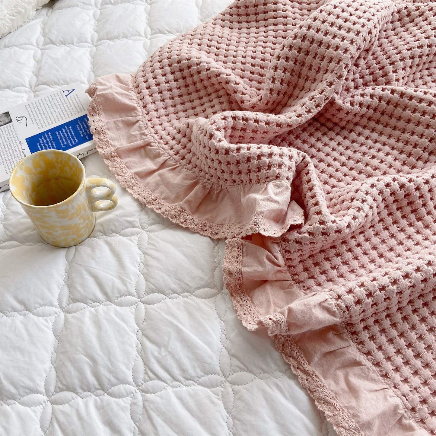 Ruffle and lace trim detail on pink cotton waffle blanket