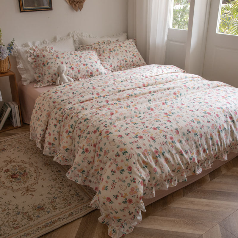 A wide shot of a child's bed with pink floral bunny duvet cover set, showcasing the full ensemble in a bright, inviting room.