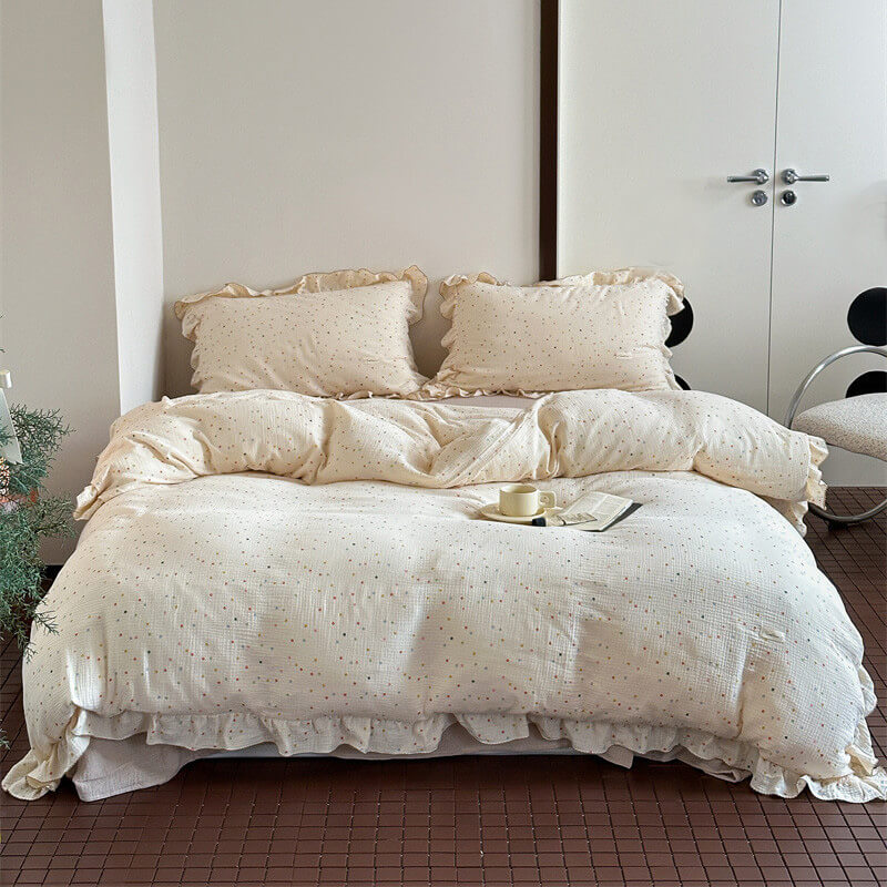 Polka dot bedding set with flat sheet and pillowcases, styled in a bedroom
